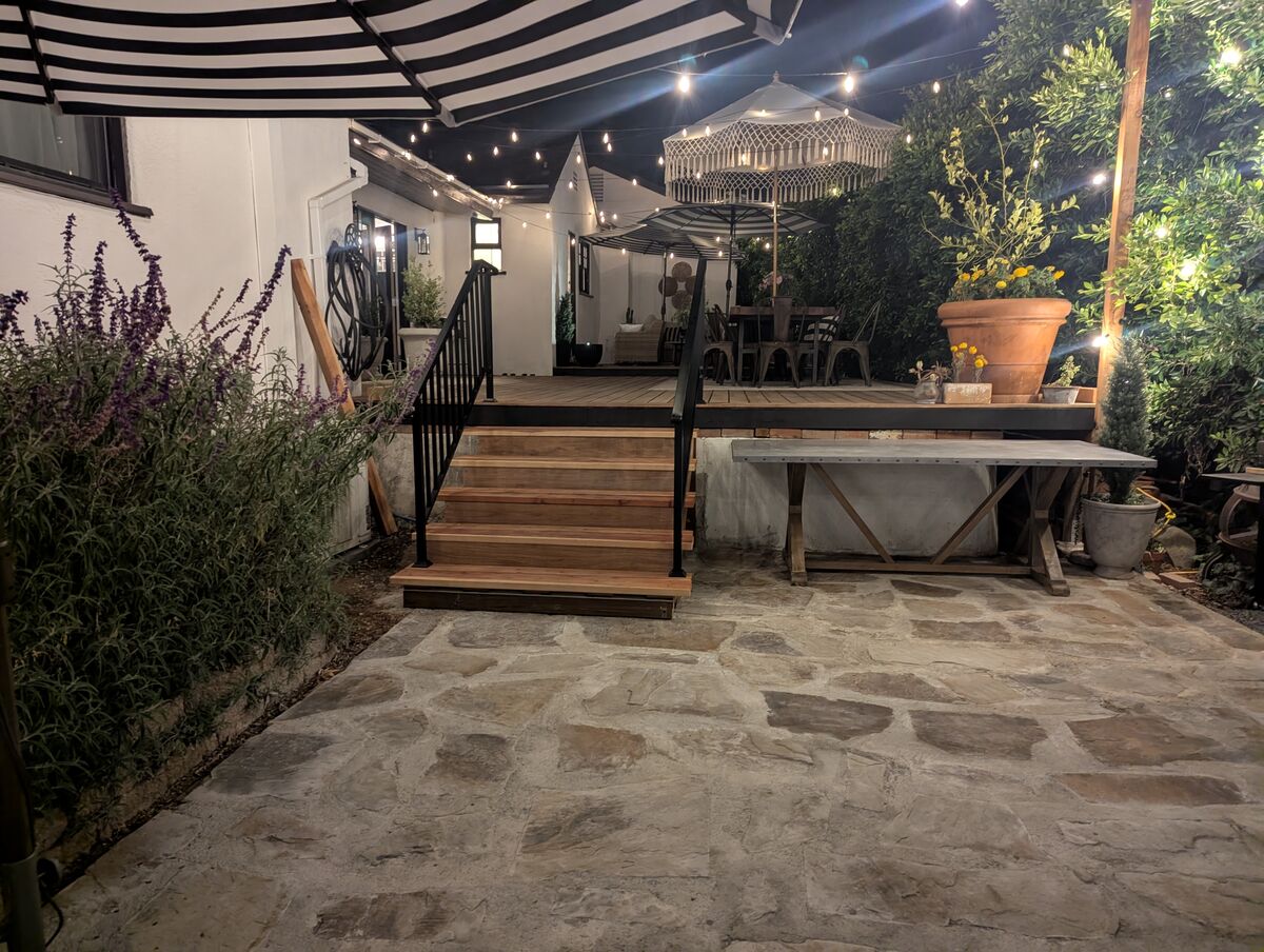 Flagstone courtyard viewed from the deck stairs at night