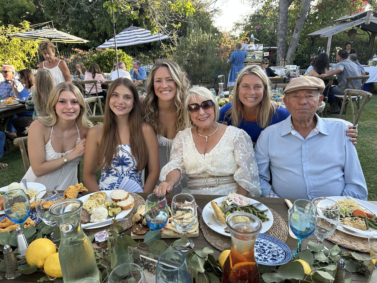 Multiple generations of family celebrating together at a garden birthday party