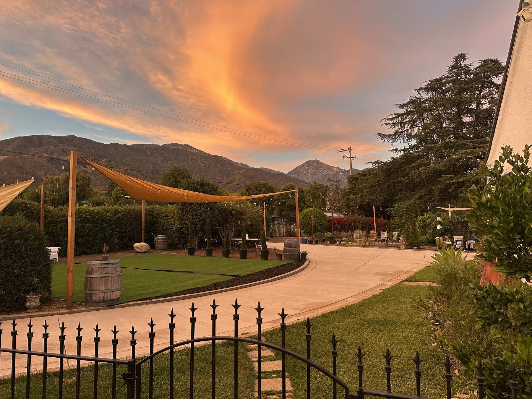 Sunset over the mountains from Villa Cuccia's garden, string lights overhead